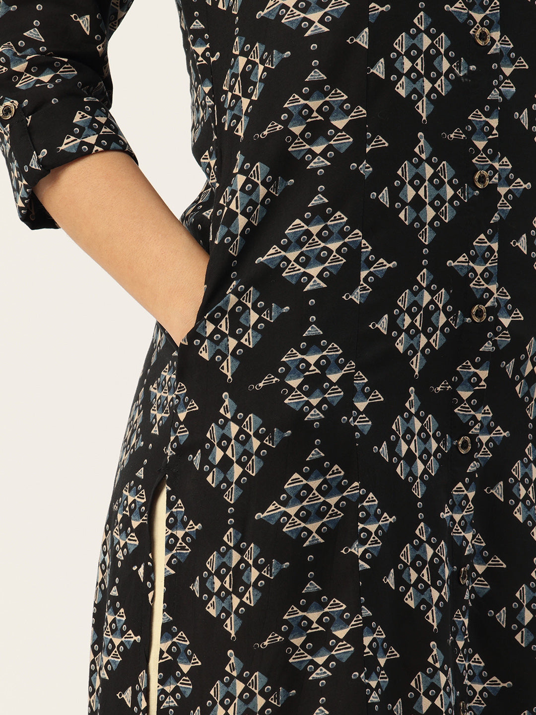 Woman wearing a black floral dress and beige pants standing in a traditional Japanese room. Black Geometric Printed Kurta, Princess Cur Kurta, A-Line Kurta, Floral Print, Mandarin Collar kurta, printed kurta